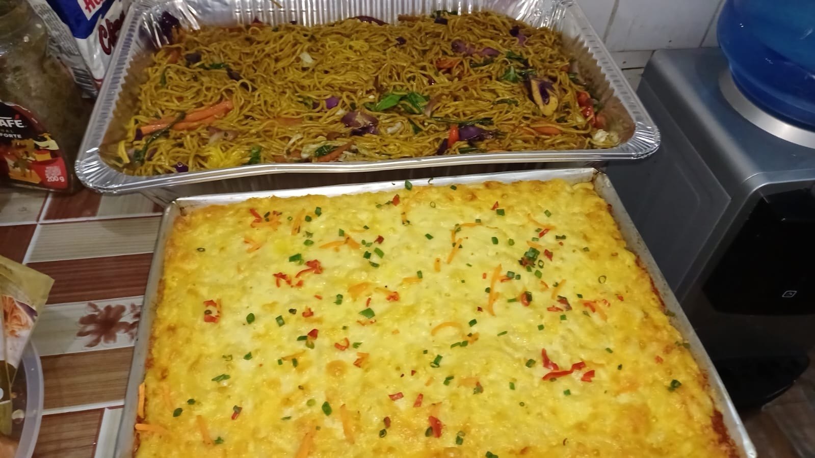 Trays of chicken chow mein and baked macaroni and cheese